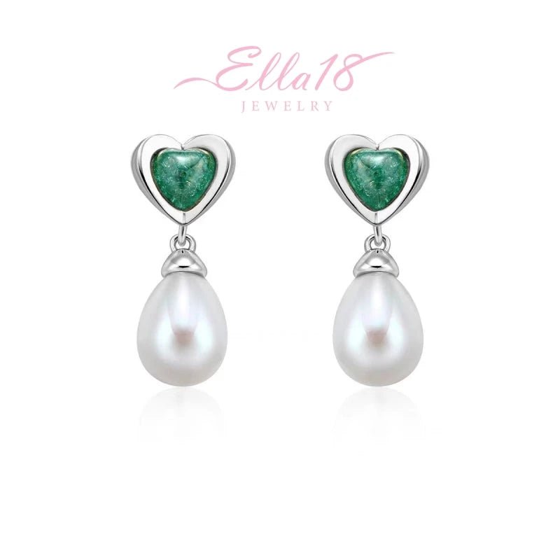 Model showcasing the dangle and style of the 18K Gold-Plated Ice Crystal Heart Pearl Earrings