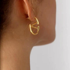 Model showcasing the dangle and style of the 18K Gold-Plated Letter V Earrings