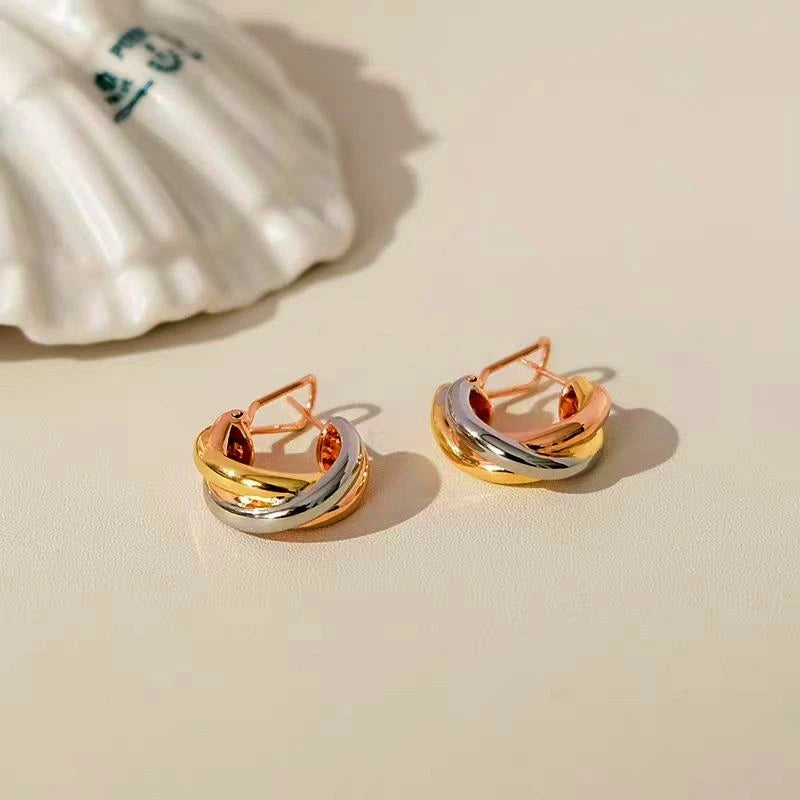 Model showcasing the dangle and style of the 18K Gold-Plated Polished Hoop Earrings