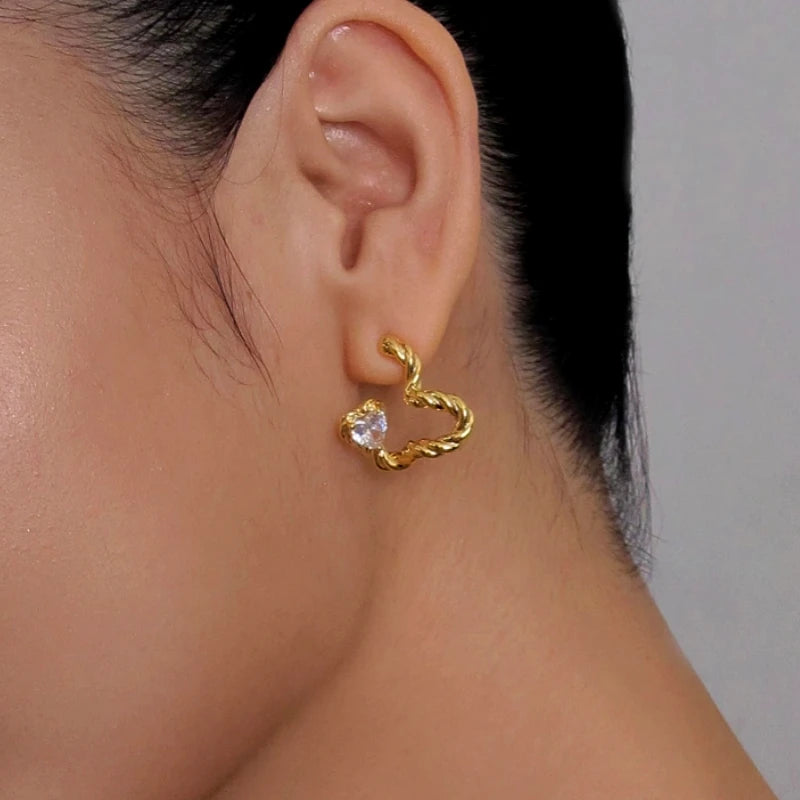 Rope twist gold open heart stud earring with heart CZ stone on ear