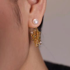 Gold pearl stud drop earring with beaded crystal cluster, worn on ear