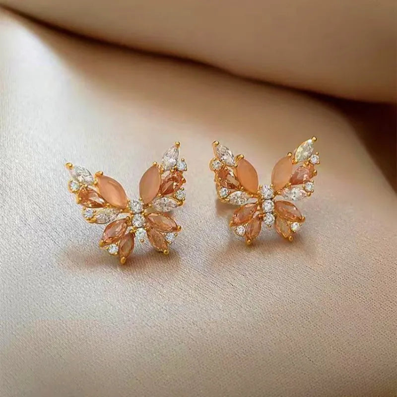 Angled view of the 18K Gold-Plated Zircon Cat's Eye Stone Butterfly Earrings