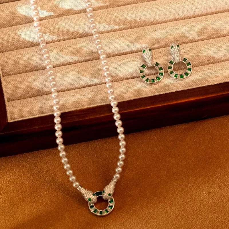 Matching snake design green gem pearl necklace and earrings set, tray display