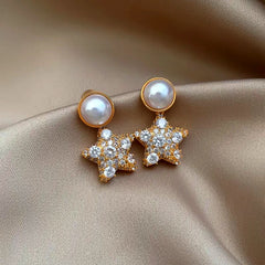 Close-up detail of the sparkling zircons and plating on the Star Pearl Earrings
