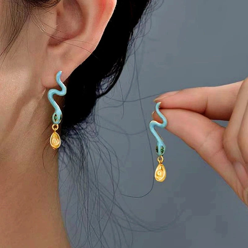Model showcasing the dangle and style of the 18K Gold-plated Ingot Snake Earrings
