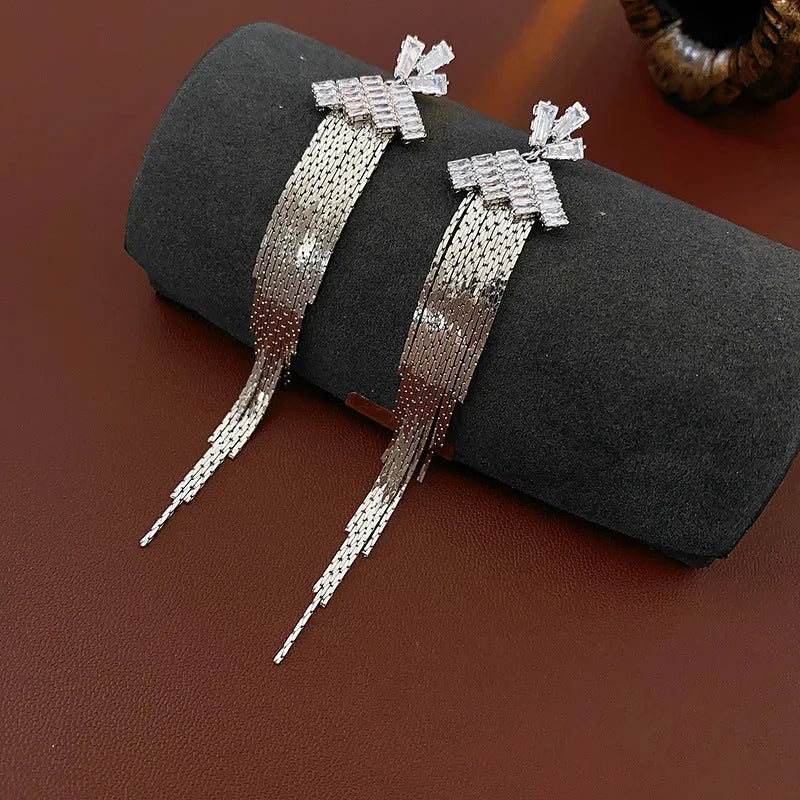 Model showcasing the dangle and style of the 14K Gold-Plated Zircon Tassel Earrings