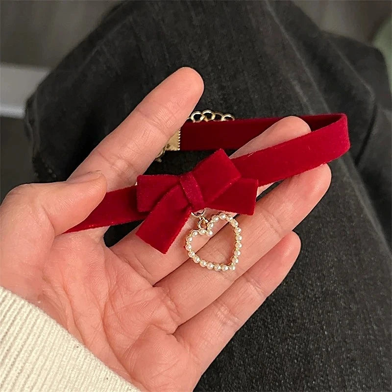 Detailed view of the Christmas Wine Red Velvet Bow Heart Choker chain and pendant