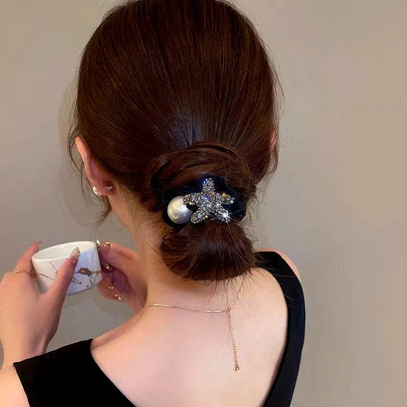 Angled view of the stylish Elegant Rhinestone Star And Pearl Hairband