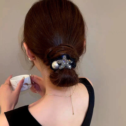 Angled view of the stylish Elegant Rhinestone Star And Pearl Hairband