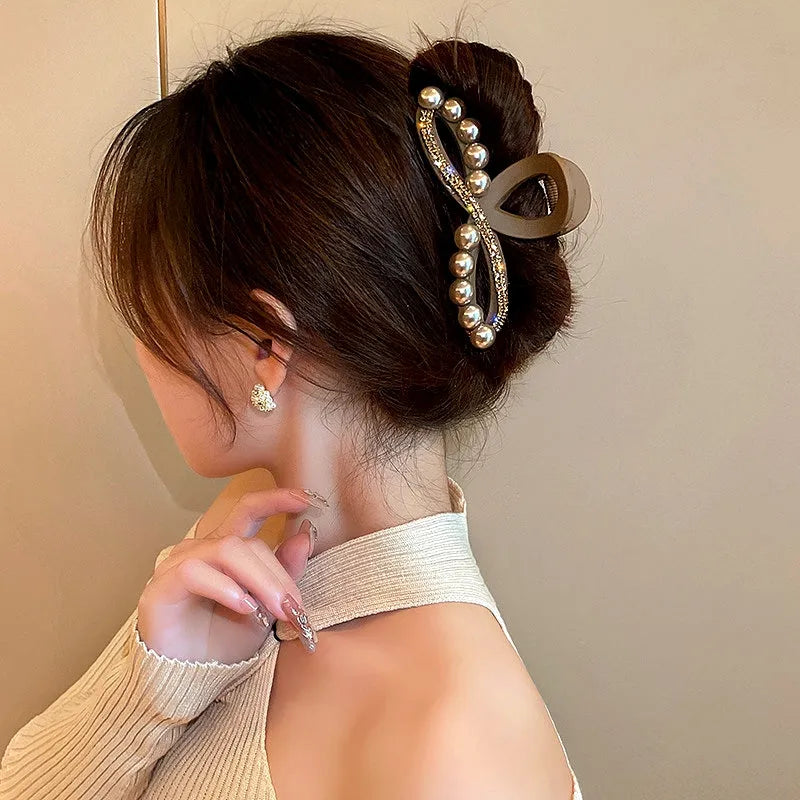 Angled view of the stylish Elegant Brown Pearl Rhinestone Hair Clips