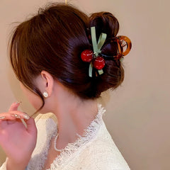 Close-up showing the material and craftsmanship of the Cherry Hair Clip