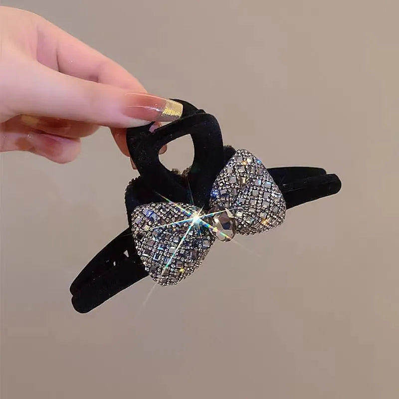 Close-up showing the material and craftsmanship of the Diamond Bow Hair Clip