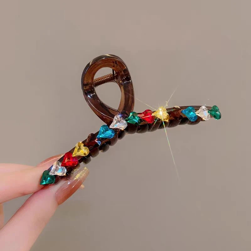 Elegant Dopamine Colored Love Acrylic Hair Clip shown for scale and size reference