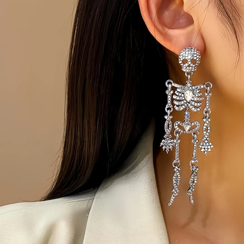 Model showcasing the dangle and style of the Halloween 14K Gold-Plated Skull Earrings