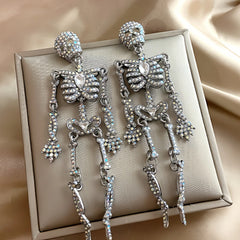 Angled view of the Halloween 14K Gold-Plated Skull Earrings