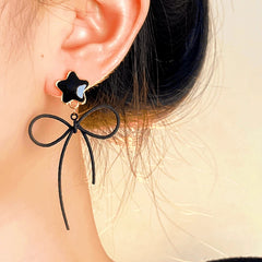 Model showcasing the dangle and style of the Halloween 14K Gold-Plated Star Bow Cat Earrings