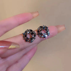 Angled view of the Silver Post Black Diamond Hoop Earrings