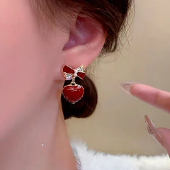 Close-up detail of the sparkling zircons and plating on the Bow Heart Earrings