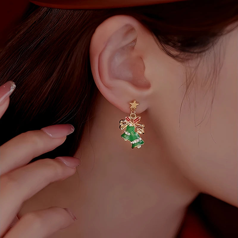 Model showcasing the dangle and style of the Silver Post Christmas Bow Bell Earrings