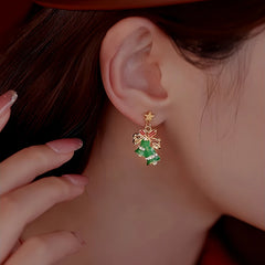 Model showcasing the dangle and style of the Silver Post Christmas Bow Bell Earrings