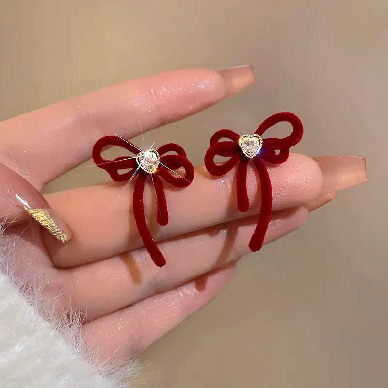 Close-up detail of the sparkling zircons and plating on the Christmas Bow Earrings