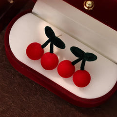 Angled view of the Silver Post Christmas Cherry Earrings