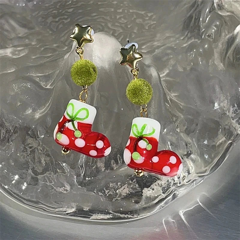 Angled view of the Silver Post Christmas Green Wool Ball Sock Earrings