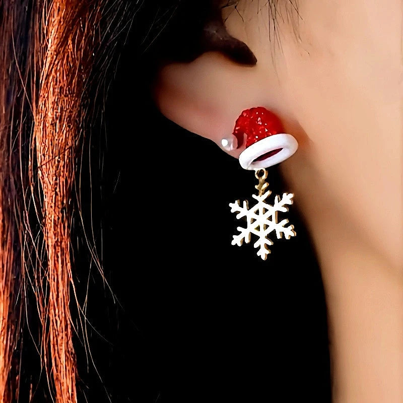Model showcasing the dangle and style of the Silver Post Christmas Hat Boots Snowflake Earrings