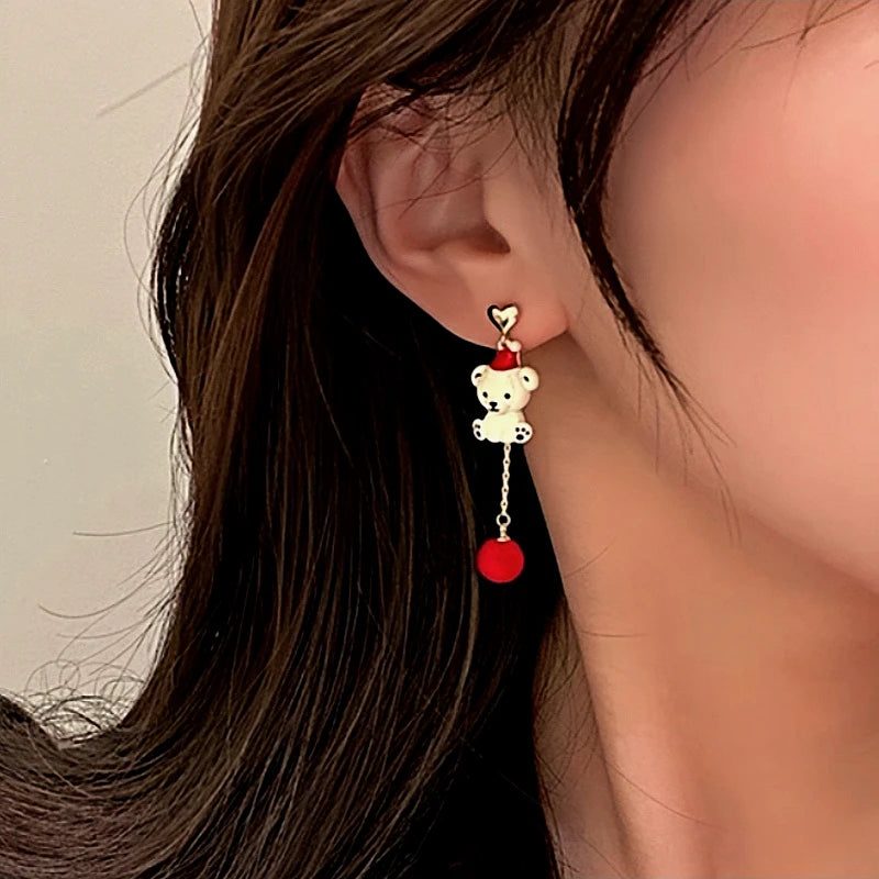 Model showcasing the dangle and style of the Silver Post Christmas Pearl Bear Earrings