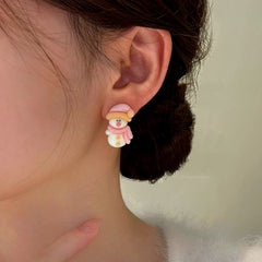 Model showcasing the dangle and style of the Silver Post Christmas Santa Flocking Earrings