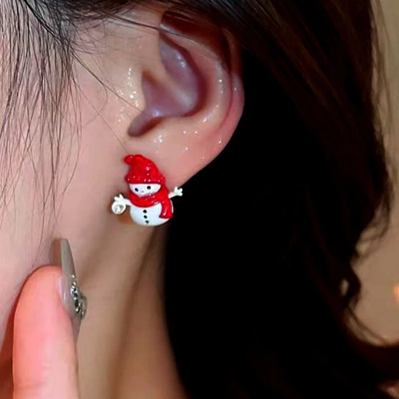 Model showcasing the dangle and style of the Silver Post Christmas Scarf Snowman Stud Earrings