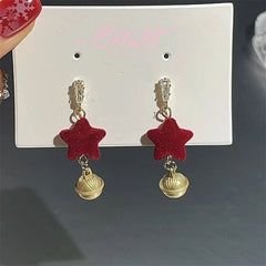 Angled view of the Silver Post Christmas Star Bell Wine Red Flocking Earrings