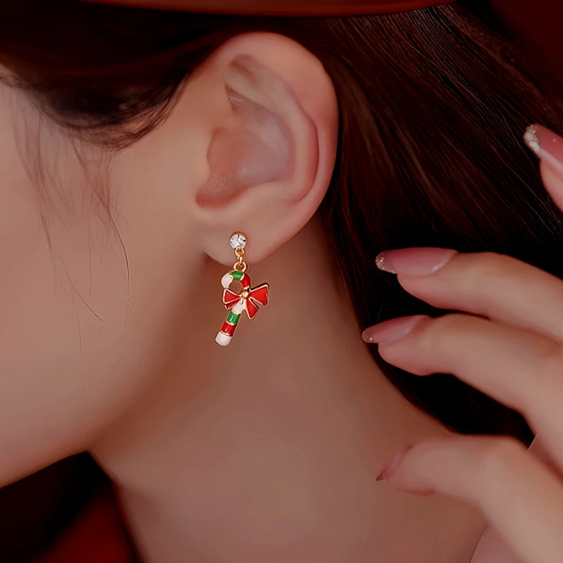 Model showcasing the dangle and style of the Silver Post Christmas Stockings Cane Asymmetrical Earrings