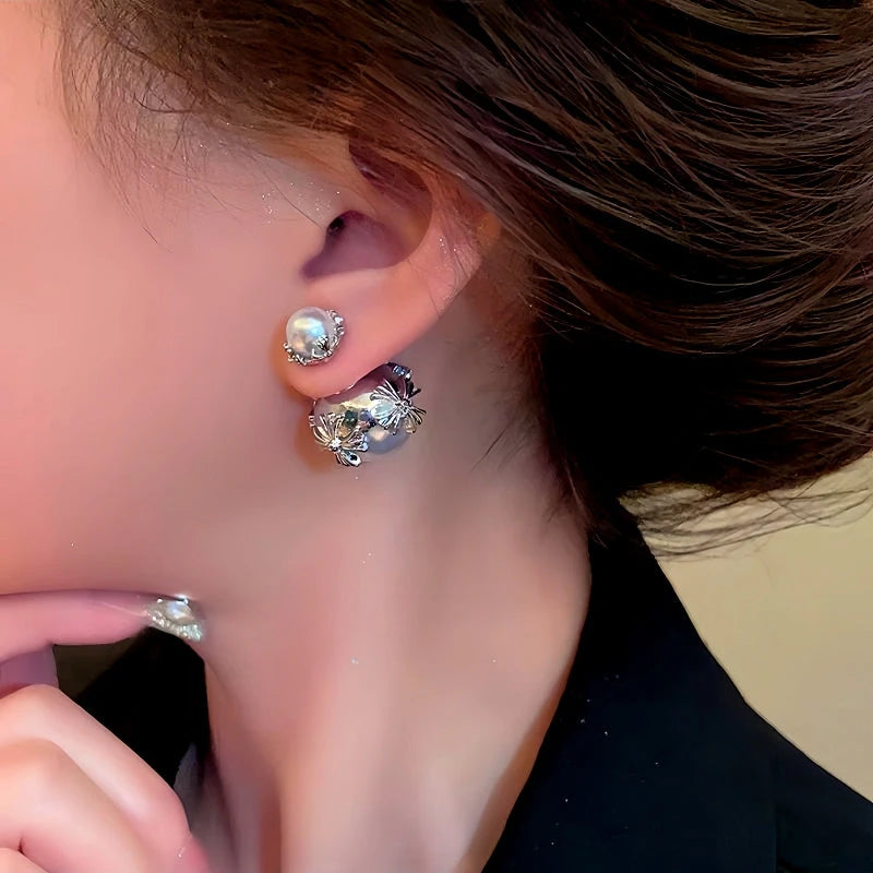 Model showcasing the dangle and style of the Silver Post Cross Pearl Earrings