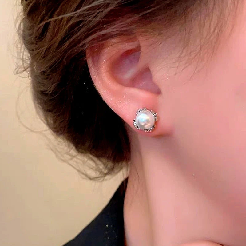 Close-up detail of the sparkling zircons and plating on the Cross Pearl Earrings
