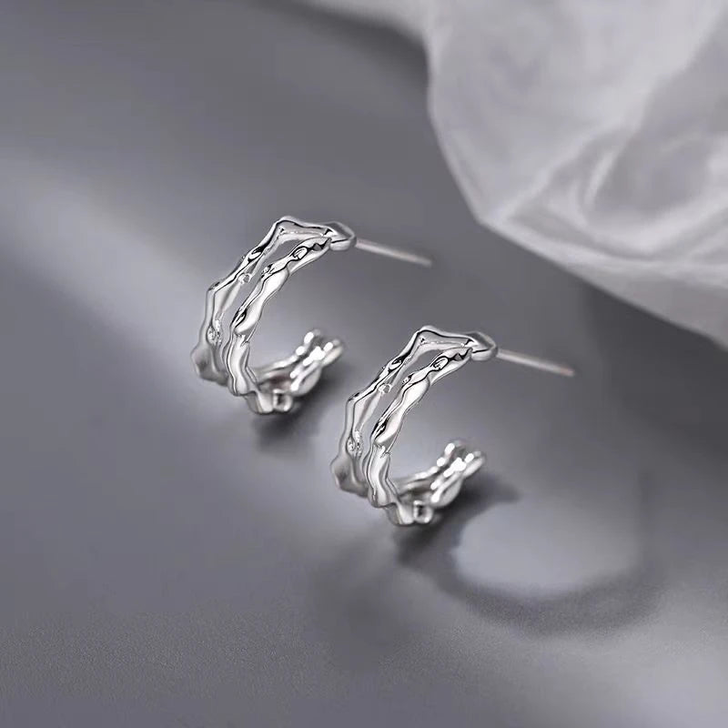 Model showcasing the dangle and style of the Silver Post Double-Layer Plain Hoop Earrings