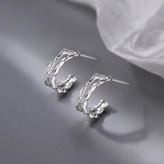 Model showcasing the dangle and style of the Silver Post Double-Layer Plain Hoop Earrings