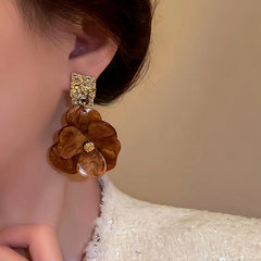 Model showcasing the dangle and style of the Silver Post Flower Earrings