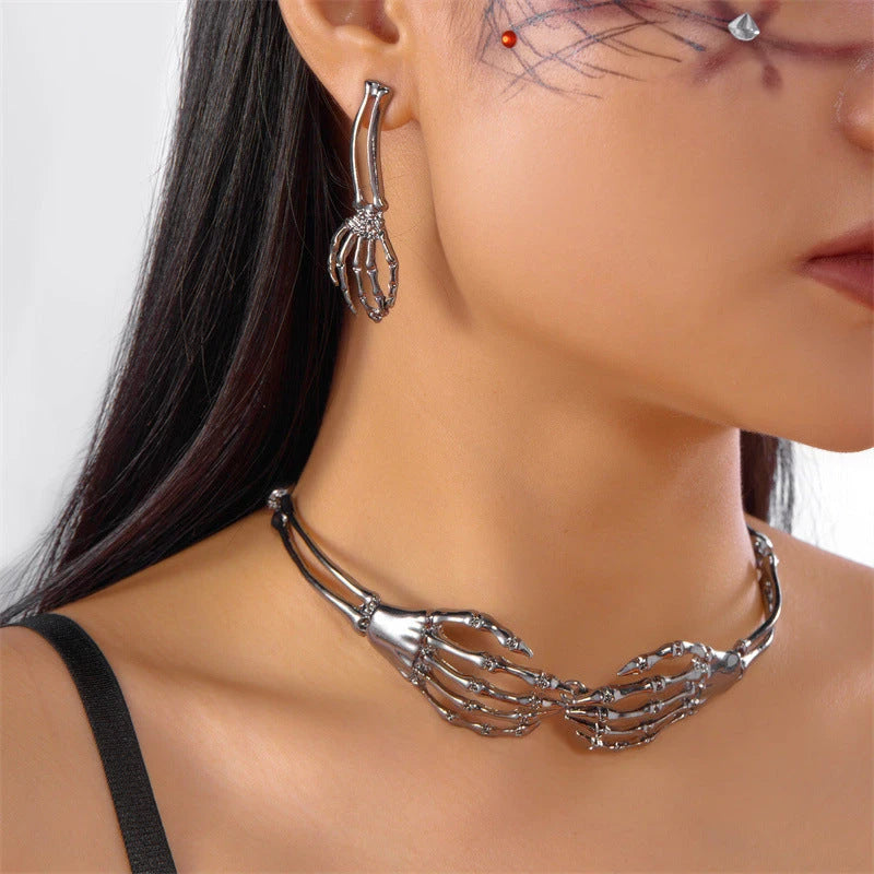 Gothic silver skeleton hand choker and matching earring worn on model, punk jewelry