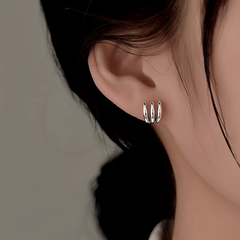 Model showcasing the dangle and style of the Silver Post Multi-Layer Claw Studs