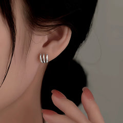 Close-up detail of the sparkling zircons and plating on the Claw Stud Earrings