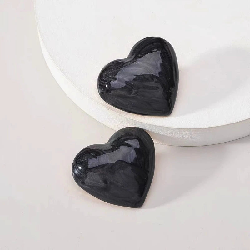 Angled view of the Silver Post Painted Heart Stud Earrings