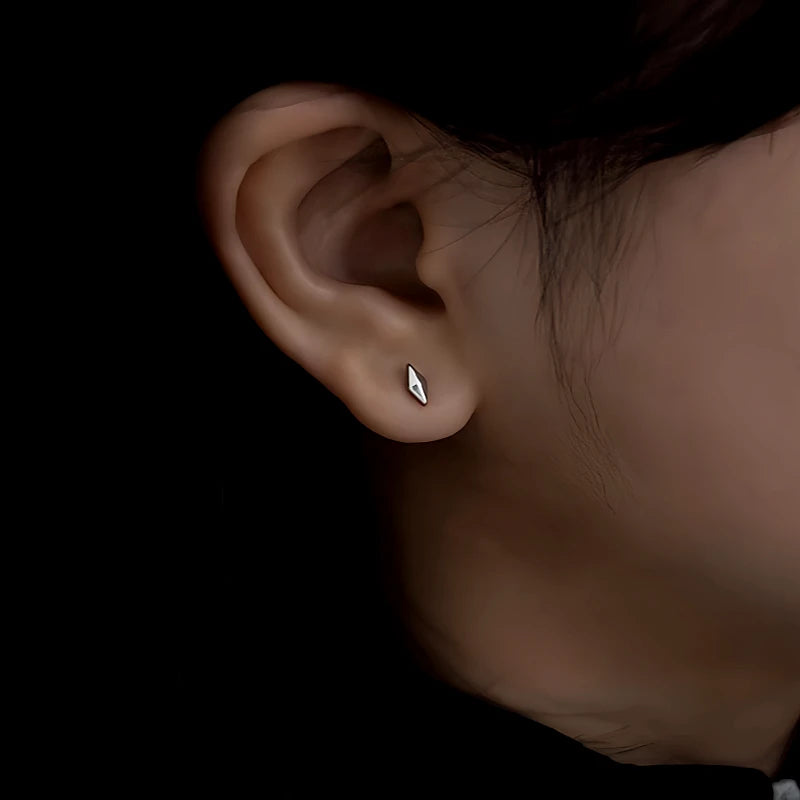 Model showcasing the dangle and style of the Silver Post Rivet Jacket Earrings