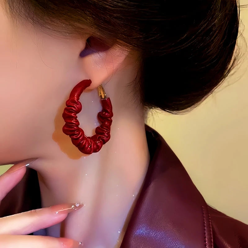 Model showcasing the dangle and style of the Silver Post Wrinkled Leather Earrings