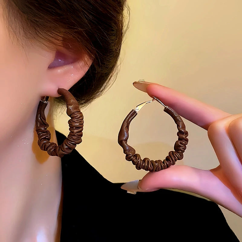 Close-up detail of the sparkling zircons and plating on the Wrinkled Leather Hoops