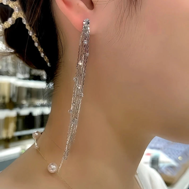 Model showcasing the dangle and style of the Silver Post Zircon Diamond Tassel Earrings