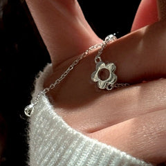 Close-up view of the gemstone and setting of the Flower Chain Ring