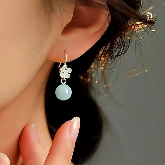 Model showcasing the dangle and style of the Sterling Silver Amazonite Flower Earrings