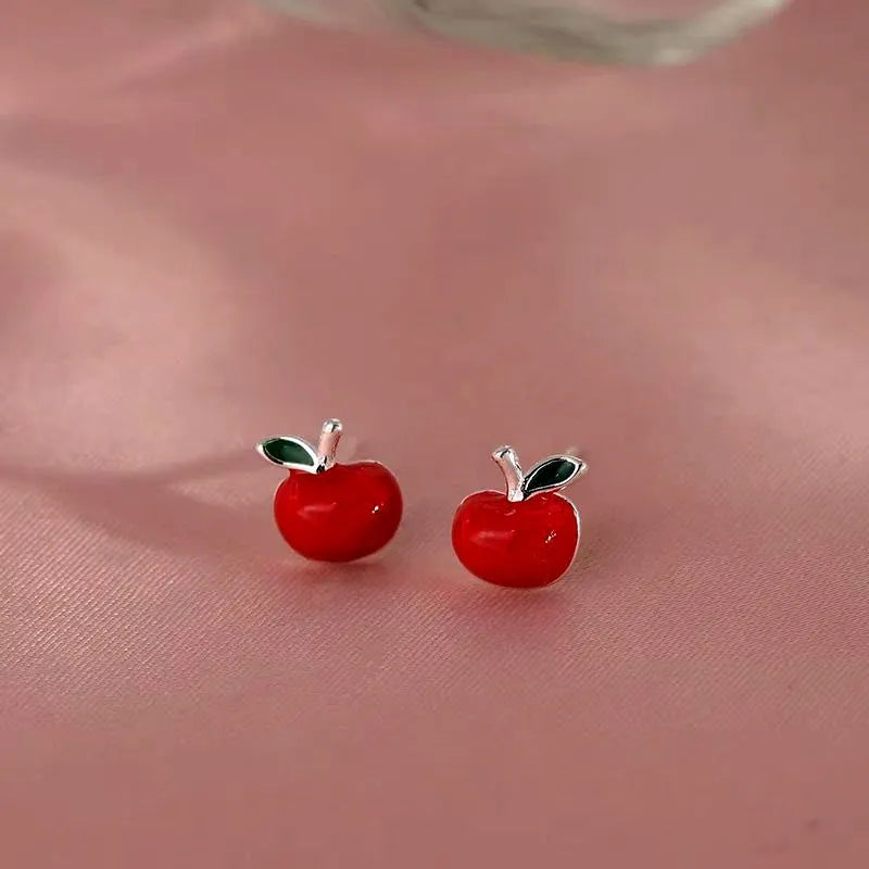 Model showcasing the dangle and style of the Sterling Silver Apple Stud Earrings