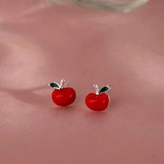 Model showcasing the dangle and style of the Sterling Silver Apple Stud Earrings